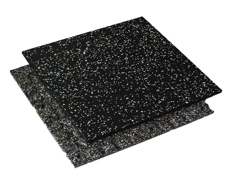 A detailed shot of the texture of a high-density black rubber gym floor.